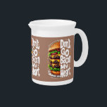 Don't Go Bacon My Heart Funny Food Pun Beverage Pitcher<br><div class="desc">This bold and humorous design features a towering, mouthwatering cheeseburger stacked high with juicy patties, dripping melted cheese, crisp lettuce, and fresh tomatoes. Paired with the clever pun, "Don't Go Bacon My Heart, " in a playful, hand-drawn font, this artwork is perfect for food lovers who appreciate a good joke....</div>