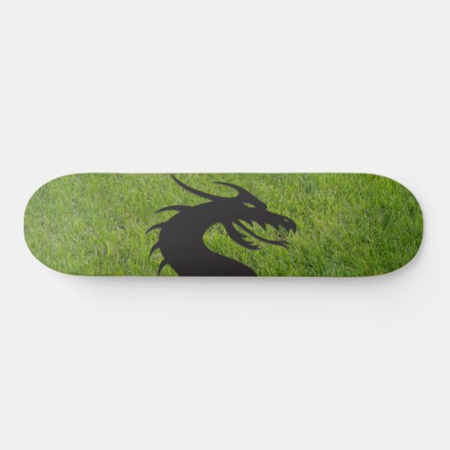 Dragon silhouette with grass in the background skateboard