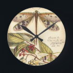 Dragonflies with Leaves and Fruit Round Clock<br><div class="desc">Dragonflies float above leaves bearing fruit in this piece by Vision Studio. The trio of insects blend amazingly well with their background,  giving this print a lifelike quality. Order your copy today!</div>