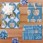 Dreidel Rustic Oak Cute Blue Photo Hanukkah Wrapping Paper Sheets<br><div class="desc">Create your own Hanukkah wrapping paper sheets with two personalized designs in the three design assortment. All based around rustic dreidels in a faux oak wood graphic, the first sheet is a series of jumbo dots in rich blue on a background of pale pastel blue. Add your photo into the...</div>