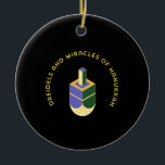 DREIDELS AND MIRACLES OF HANUKKAH CERAMIC ORNAMENT<br><div class="desc">This stylized illustration features a dreidel colored yellow, purple, and green against a stark black background. A curved gold text above it reads "DREIDELS AND MIRACLES OF HANUKKAH", highlighting the traditional toy and the spiritual celebration of the Jewish holiday. The design has a clean, geometric aesthetic with a touch of...</div>