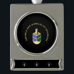 DREIDELS AND MIRACLES OF HANUKKAH SILVER PLATED BANNER ORNAMENT<br><div class="desc">This stylized illustration features a dreidel colored yellow, purple, and green against a stark black background. A curved gold text above it reads "DREIDELS AND MIRACLES OF HANUKKAH", highlighting the traditional toy and the spiritual celebration of the Jewish holiday. The design has a clean, geometric aesthetic with a touch of...</div>