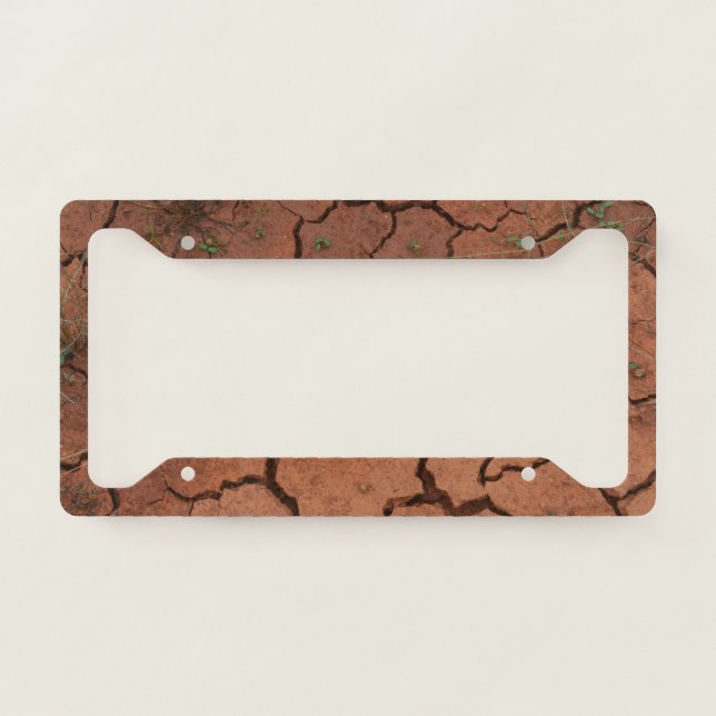 dry, cracked ground license plate frame (Front)