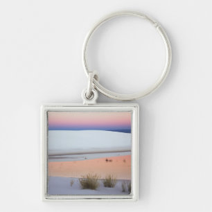 Dusk sky reflected in pool of water from keychain