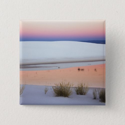Dusk sky reflected in pool of water from pinback button