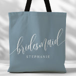 Dusty Blue Bridesmaid Modern Script Tote Bag<br><div class="desc">Show your appreciation to your bridal party with this stylish dusty blue bridesmaid tote bag. Featuring modern script and customizable with your bridesmaid's name, this tote bag is both practical and elegant. The soft color and chic design make it perfect for carrying wedding day essentials or everyday items. This personalized...</div>