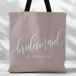 Dusty Lavender Bridesmaid Modern Script Tote Bag<br><div class="desc">Show your appreciation to your bridal party with this stylish dusty lavender purple bridesmaid tote bag. Featuring modern script and customizable with your bridesmaid's name, this tote bag is both practical and elegant. The soft color and chic design make it perfect for carrying wedding day essentials or everyday items. This...</div>