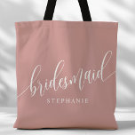 Dusty Rose Pink Bridesmaid Modern Script Tote Bag<br><div class="desc">Show your appreciation to your bridal party with this stylish dusty rose pink bridesmaid tote bag. Featuring modern script and customizable with your bridesmaid's name, this tote bag is both practical and elegant. The soft color and chic design make it perfect for carrying wedding day essentials or everyday items. This...</div>