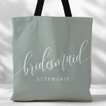 Dusty Sage Bridesmaid Modern Script Tote Bag<br><div class="desc">Show your appreciation to your bridal party with this stylish dusty sage green bridesmaid tote bag. Featuring modern script and customizable with your bridesmaid's name, this tote bag is both practical and elegant. The soft color and chic design make it perfect for carrying wedding day essentials or everyday items. This...</div>