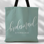 Dusty Teal Bridesmaid Modern Script Tote Bag<br><div class="desc">Show your appreciation to your bridal party with this stylish dusty teal bridesmaid tote bag. Featuring modern script and customizable with your bridesmaid's name, this tote bag is both practical and elegant. The soft color and chic design make it perfect for carrying wedding day essentials or everyday items. This personalized...</div>