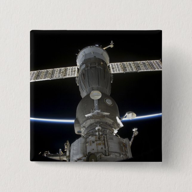 Earth's limb intersects a Soyuz spacecraft Button (Front)