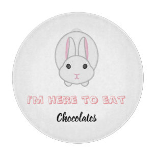 Easter bunny waiting to eat chocolates          cutting board