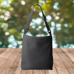 Eerie Black Solid Color Crossbody Bag<br><div class="desc">An intense and sophisticated deep black that exudes timeless elegance.Perfect for those seeking to make a bold statement.This powerful hue captures the essence of mystery and sophistication.This rich black color is the ultimate choice for a striking and refined aesthetic.</div>