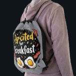 Egg-cited for Breakfast Funny Foodie Pun Design Drawstring Bag<br><div class="desc">Start your morning with a smile with this playful "Egg-cited for Breakfast" design, perfect for food lovers and brunch enthusiasts alike. Featuring a charming hand-drawn style, this artwork showcases two sunny-side-up eggs alongside crispy bacon strips, all set against a whimsical backdrop of scattered seasonings and vibrant typography. The warm yellow...</div>