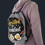 Egg-cited for Breakfast Funny Foodie Pun Design Drawstring Bag<br><div class="desc">Start your morning with a smile with this playful "Egg-cited for Breakfast" design, perfect for food lovers and brunch enthusiasts alike. Featuring a charming hand-drawn style, this artwork showcases two sunny-side-up eggs alongside crispy bacon strips, all set against a whimsical backdrop of scattered seasonings and vibrant typography. The warm yellow...</div>