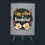 Egg-cited for Breakfast Funny Foodie Pun Design Tripod Lamp<br><div class="desc">Start your morning with a smile with this playful "Egg-cited for Breakfast" design, perfect for food lovers and brunch enthusiasts alike. Featuring a charming hand-drawn style, this artwork showcases two sunny-side-up eggs alongside crispy bacon strips, all set against a whimsical backdrop of scattered seasonings and vibrant typography. The warm yellow...</div>