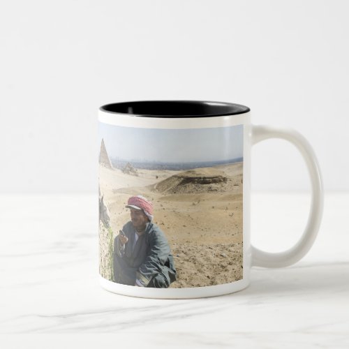 Egypt Giza Native man feeds his camel in Two_Tone Coffee Mug