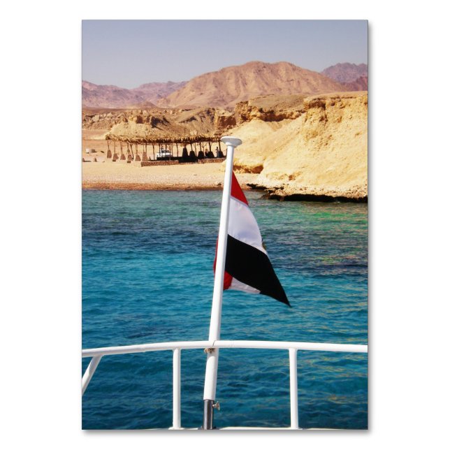 Egyptian flag on the background of the azure water table number (Front)