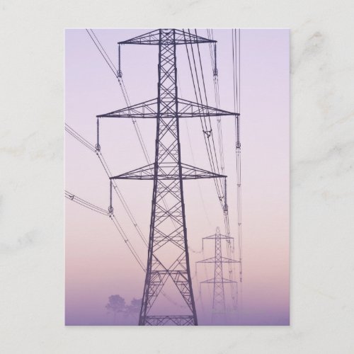 Electricity pylons in mist at dawn postcard