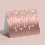 Elegant 70th Birthday Party Rose Gold Glitter Thank You Card<br><div class="desc">Chic folded thank you card for your 70th birthday party featuring "Thank You" in an elegant white calligraphy script,  a rose gold faux foil background and rose gold faux glitter. Personalize your thank you message and signature on the inside,  or leave blank for a handwritten note.</div>