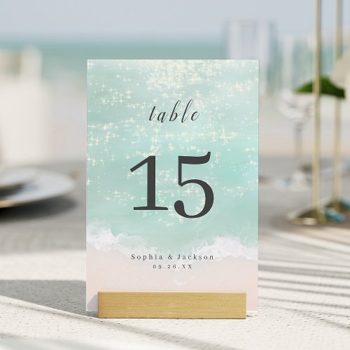 Elegant abstract sparkling ocean beach wedding table number