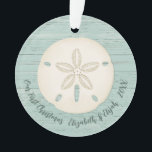 Elegant Beach Sand Dollar Photo First Christmas Ce Ornament<br><div class="desc">A joyful Christmas ornament with a sand dollar and a weathered wood background for your 1st Christmas Celebration. Great for newlyweds. Put a beach honeymoon photo on the back. Personalize the front with your names and the year. Designed for you by Blackberry Boulevard.</div>