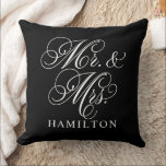 Elegant Black Mr and Mrs Script Wedding Throw Pillow<br><div class="desc">An elegant black throw pillow featuring Mr. and Mrs. in flowing white calligraphy script with a customizable family name. The bold white-on-black contrast delivers a dramatic,  modern wedding gift or striking newlywed home accent. All text is fully editable to personalize with the couple's name.</div>