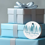 Elegant Blue Winter Trees Custom Christmas Party Favor Tags<br><div class="desc">An elegant row of winter fir trees and snowflakes above your personalized Merry Christmas script and your family last name in pretty blue below the snow filled forest. Modern holiday family party favor tag with your custom message.</div>