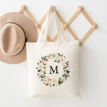 Elegant Blush Floral and White Magnolias Monogram Tote Bag<br><div class="desc">Step up your tote game with our stylish Watercolor Magnolias personalized tote bags. The elegant tote bag features your custom monogram or initial surrounded by a wreath of white magnolias and blush pink watercolor flowers complimented by brown and green leaves. The floral wreath tote bags are perfect for the bride-to-be,...</div>