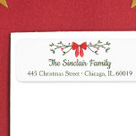Elegant Bow & Holly Personalized Christmas Return  Label<br><div class="desc">Add a touch of festive elegance to your holiday mailings with this charming personalized Christmas return address label. Featuring a classic red bow with holly accents and customizable family name and address text, it’s perfect for sending holiday cheer with style. The refined red and green color palette brings a cozy,...</div>