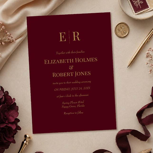 Elegant Burgundy Gold Monogram Wedding Invitation (Elegant Burgundy Gold Monogram Wedding Invitation on a table with burgundy wedding decoration)