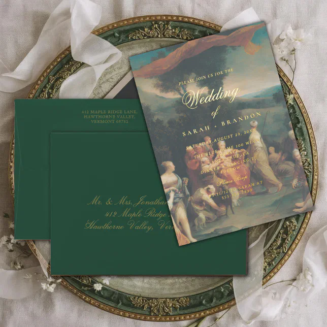 A wedding invitation with a baroque-inspired gardenscape painting, placed on a decorative plate with lace cloth.