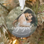 Elegant Engaged First Christmas Custom Photo Ornament<br><div class="desc">Celebrate the joy of your engagement with this Elegant "Engaged" First Christmas Ornament. Inspired by a sophisticated, minimalist style, this design allows you to showcase a beautiful engagement photo alongside custom details like your names and engagement YEAR. The ornament features elegant script text for the word "Engaged, " creating a...</div>