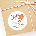 Elegant Fall in Love Autumn Wedding Monogram Classic Round Sticker<br><div class="desc">"Fall in Love" themed wedding favor stickers feature an orange maple leaf and chocolate brown customizable monogram of the bride and groom's names and wedding date.  Ivory / ecru background color.</div>