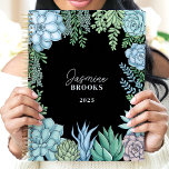 Elegant Floral Watercolor Succulent Custom Name Planner<br><div class="desc">This elegant design showcases a watercolor frame of succulents in soft green, blue, and blush hues, set against a sleek black background. The personalized name and year create a unique and refined touch, making it perfect for students, professionals, or plant enthusiasts. Ideal for organizing daily tasks, journaling, or planning with...</div>