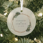 Elegant Geometric Newlywed Our First Christmas Glass Ornament<br><div class="desc">Did you get married this year? Add a memory to your Christmas tree with this modern wedding keepsake ornament with a gold geometric frame surrounded by greenery and white flowers. Inside of the frame are your names and wedding date. This ornament also makes a great gift for a newlywed couple...</div>