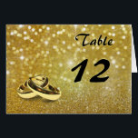 Elegant Glitter Wedding Rings - Table Number Card<br><div class="desc">Elegant and luxurious gold design illustration: 2 golden wedding rings on a gold glitter and bokeh background with sparkling bright stars.</div>