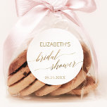 Elegant Gold Calligraphy Bridal Shower Favor Classic Round Sticker<br><div class="desc">These elegant gold calligraphy bridal shower stickers are perfect for a simple wedding shower. The neutral design features a minimalist sticker decorated with romantic and whimsical faux gold foil typography. Personalize the stickers with the name of the bride-to-be and the shower date. Please Note: This design does not feature real...</div>