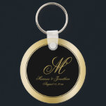 Elegant Gold Monogram Script Black Wedding Keychain<br><div class="desc">These elegant custom wedding key chains will add the perfect touch to your wedding favor gifts. This chic design template features a background of faux gold and black. In the center is the groom's last name monogram initial, bride and groom's first names and wedding date to personalize. Please check out...</div>