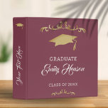 Elegant Gold Ornament Graduate Graduation Album 3 Ring Binder<br><div class="desc">Elegant Gold Ornament Graduate Graduation Album 3 ring binder. Graduation binder with graduation cap,  trendy script and gold ornaments on burgundy red background. Personalize with your name. Personalize the text on the spine.</div>