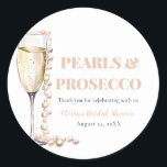 Elegant Gold Pearls and Prosecco Bridal Shower Classic Round Sticker<br><div class="desc">The "Elegant Gold Pearls and Prosecco Bridal Shower Sticker" is a charming addition to any bridal celebration. Adorned with elegant designs inspired by gold pearls and the effervescence of Prosecco, these stickers add a touch of sophistication to invitations, favors, or décor items. Meticulously crafted and beautifully presented, these stickers are...</div>
