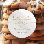 Elegant Gold Script Wedding Thank You Sticker<br><div class="desc">Add a touch of elegance to your wedding favors with this classic round thank you sticker. Featuring a minimalist gold script with a heart-shaped rope design and personalized names,  it’s the perfect way to thank your guests in style. Ideal for cookie bags,  boxes,  or custom wedding favors.</div>