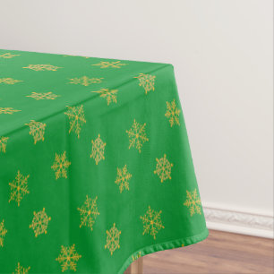 Elegant Golden Snowflake Pattern on Green Tablecloth