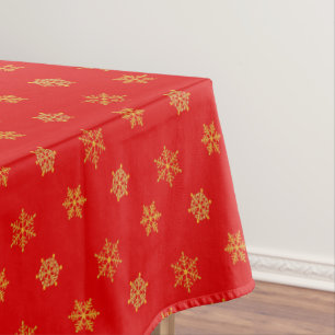 Elegant Golden Snowflake Pattern on Red Tablecloth