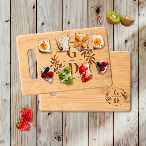 Elegant initials and branch with leaves wedding cutting board