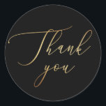 Elegant Minimalist Gold & Black Wedding Thank You Classic Round Sticker<br><div class="desc">Show your appreciation in style with this elegant round thank you sticker. Featuring graceful gold style script on a bold black background, this design adds a sophisticated finish to your wedding favors, envelopes, or gift packaging. The gold lettering is a printed effect (not real foil), offering a luxurious look with...</div>