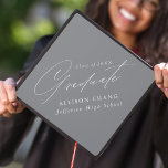 Elegant Minimalist Gray Graduation Cap Topper<br><div class="desc">Elegant graduation cap topper featuring "Graduate" displayed in a beautiful white calligraphy script with a gray background. Personalize the graduation cap topper with the graduate's name,  school name,  and graduation year.</div>