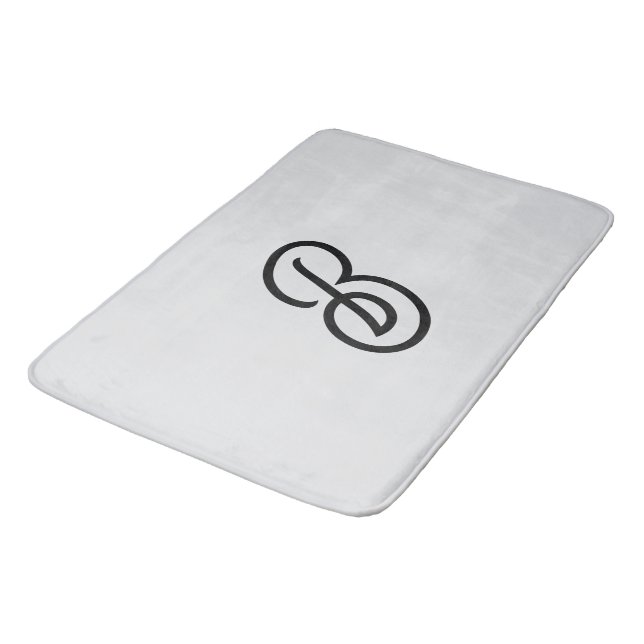 Elegant minimalist modern initial on gray bath mat (Angled)
