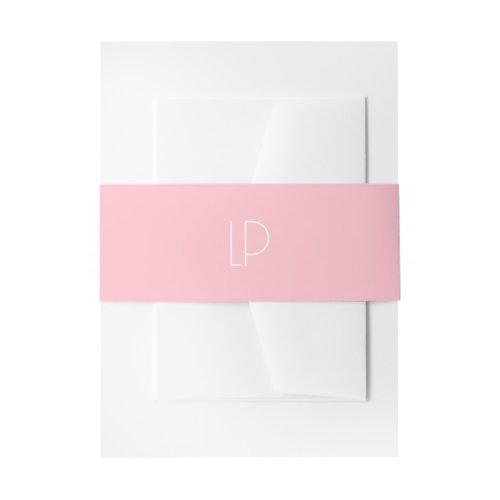 Elegant minimalist modern initial on pastel pink invitation belly band