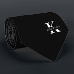 Elegant Monogram | Black White Neck Tie<br><div class="desc">An elegant necktie featuring a bold white monogram across a black background. Atop this monogram sits your first or last name spelled out in all capitals. If you prefer a bolder look for the personal name inside of the large letter you can do the following: Use the customize/ edit function...</div>